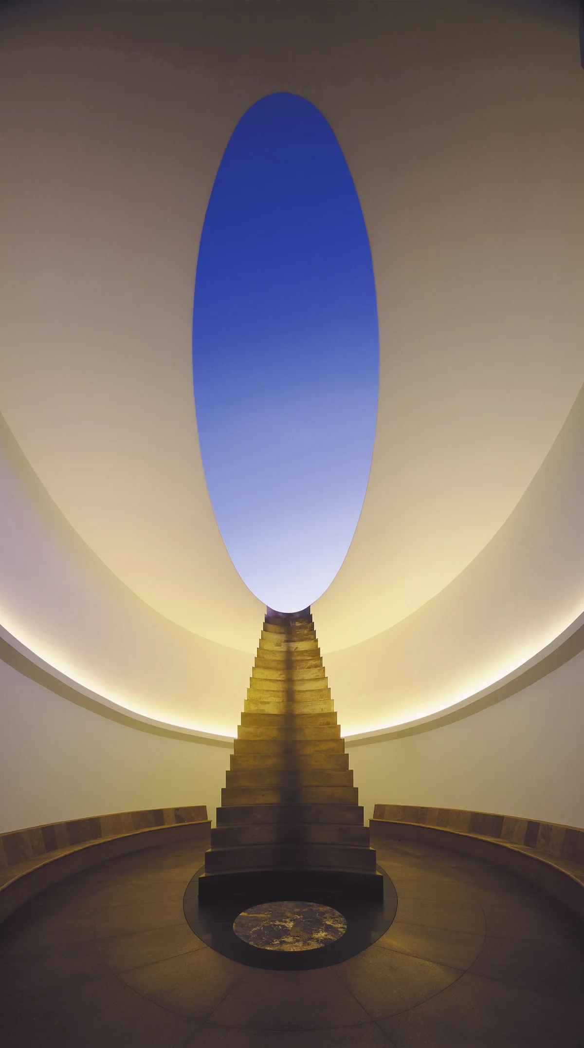 Interior of James Turrell’s Roden Crater, with an aperture open to the sky and stairs descending into the space