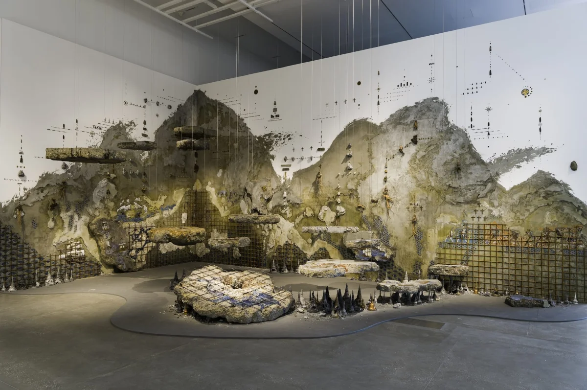 A gallery installation assembled from found objects, plaster, and other materials