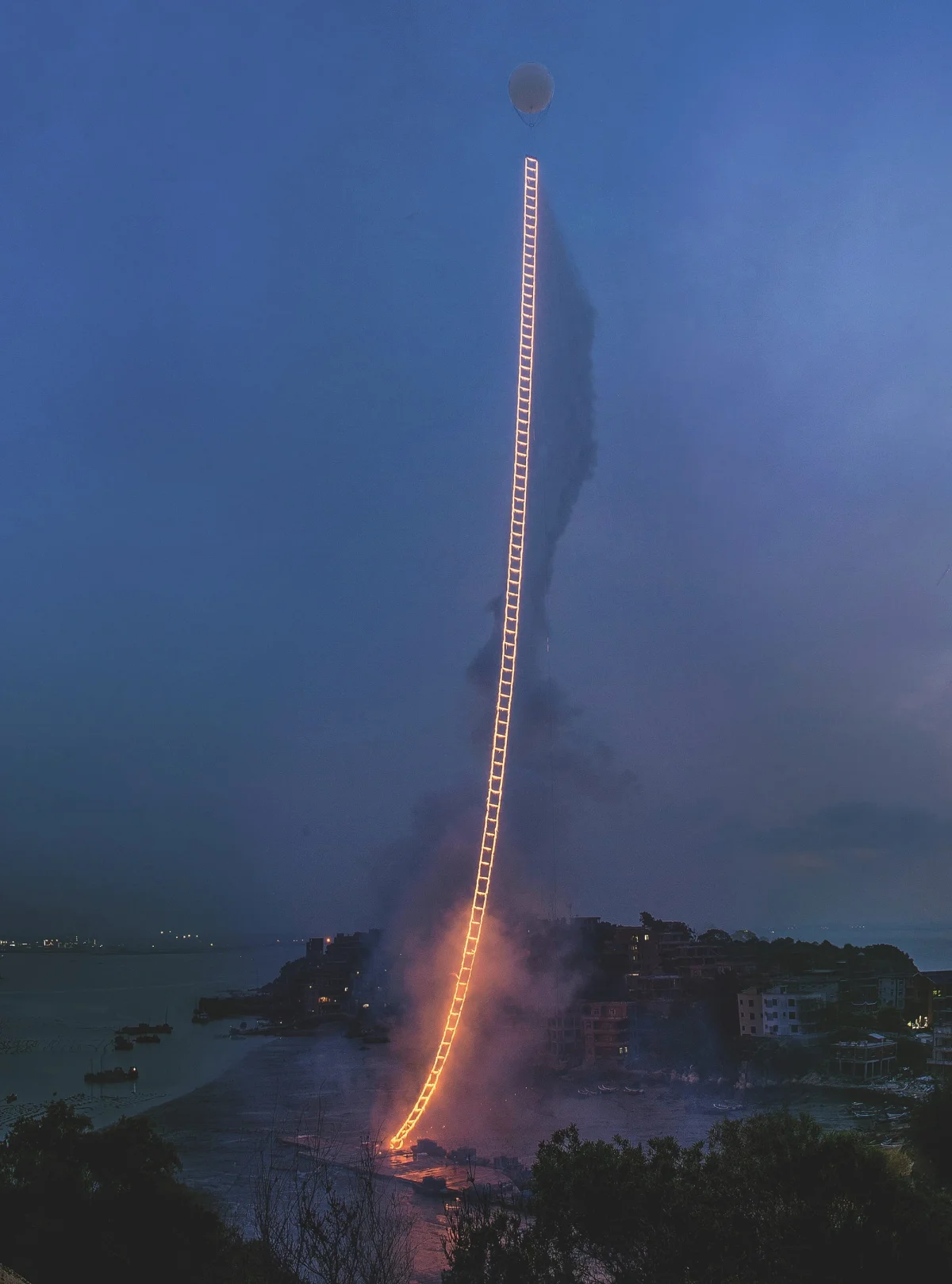 Cai Guo-Qiang’s gunpowder ladder suspended in the sky and set ablaze
