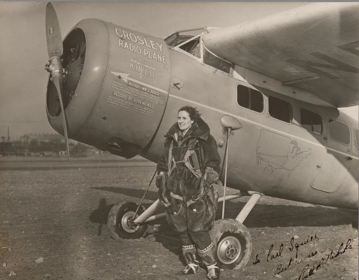 pilot Ruth Nichols stands next to her plane in a 1931 black-and-white photo