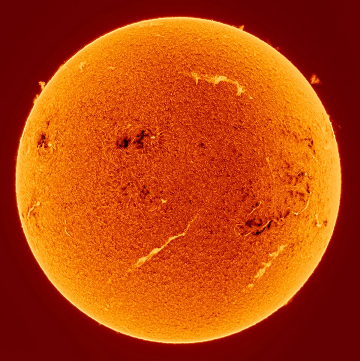 an up-close photo of the sun with flares and dark spots