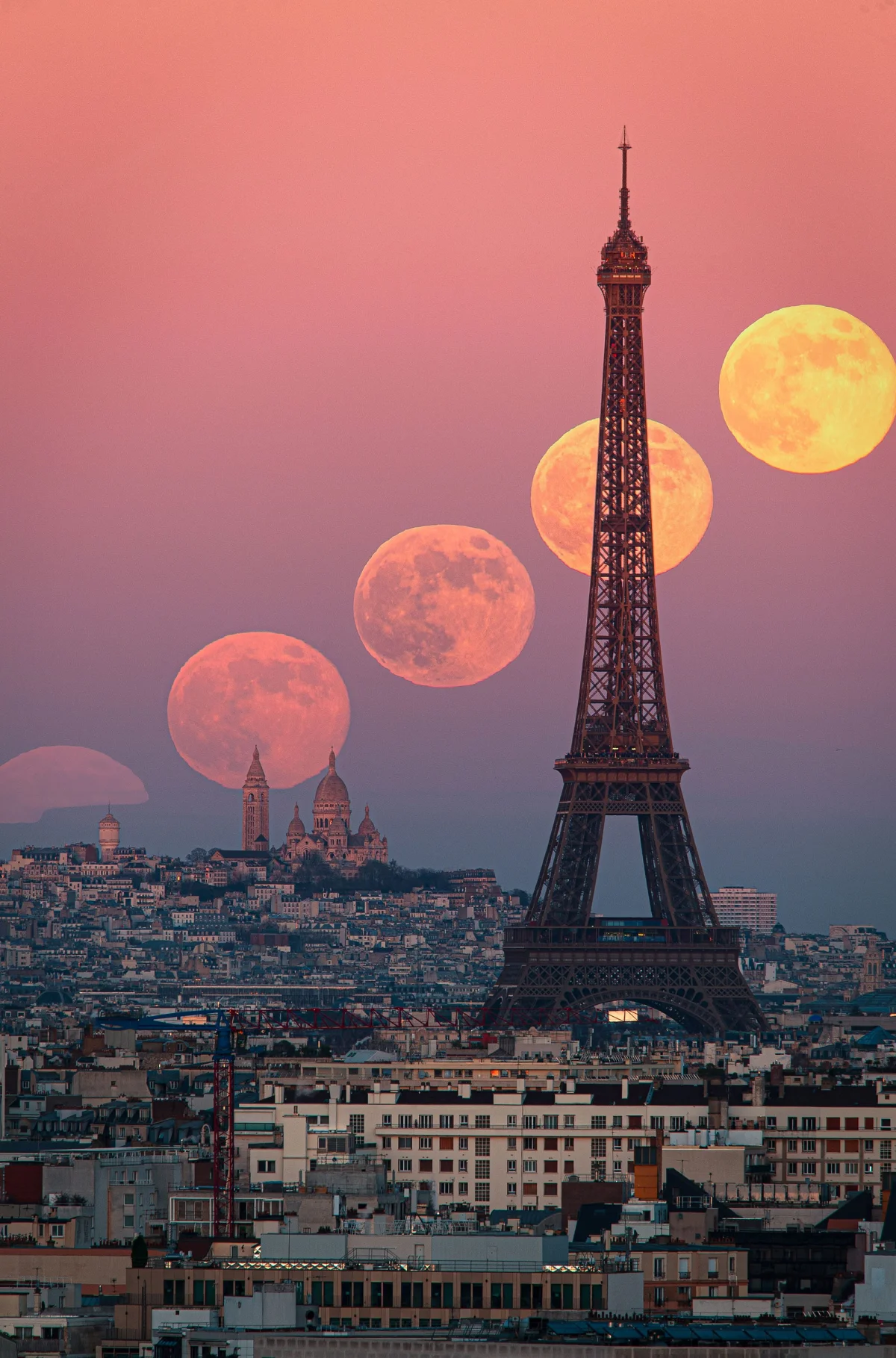 an astronomy photo of the moon phases as it rises behind the Eiffel Tower