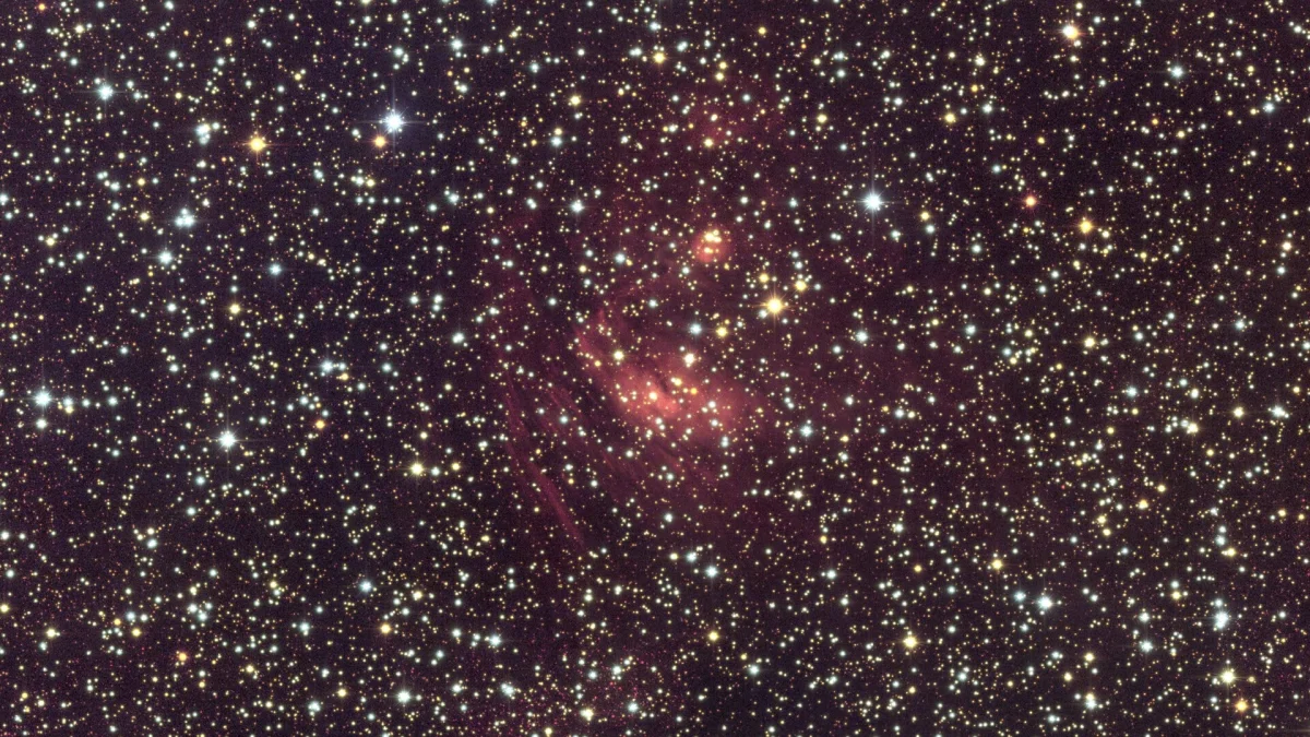 a tight view of a very detailed photograph of the bulge in the center of the Milky Way galaxy showing a nebula